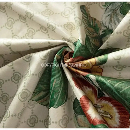 Cream-colored cushion covers with gucci monogram and green red yellow floral prints for decorbites dream floral design