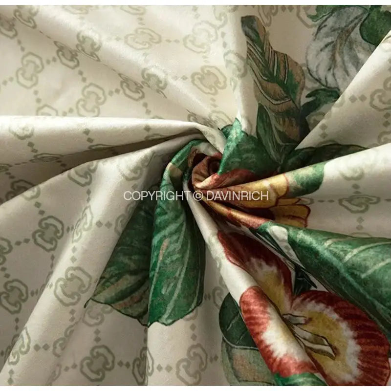 Cream-colored cushion covers with gucci monogram and green red yellow floral prints for decorbites dream floral design