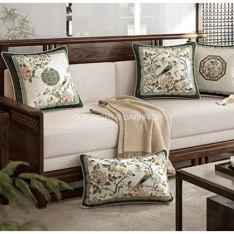 Elegant cream cushion cover with intricate peach green and gold dream floral birds embroidery on textured fabric