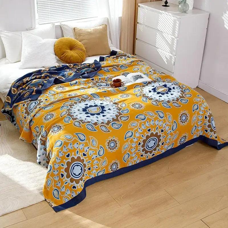 Vibrant yellow decorbites cotton gauze throw blanket with navy blue paisley and floral patterns for bedroom decor