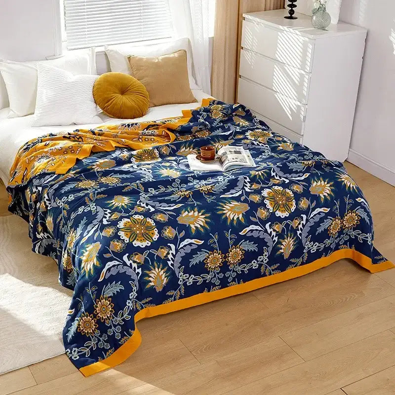 Embroidered floral blue and cream decorbites cotton gauze bedroom blanket with navy blue and gold pattern and yellow border