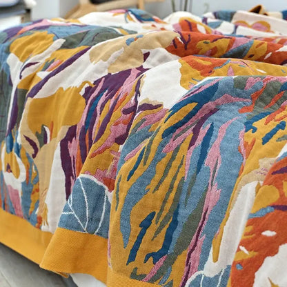 Vibrant multicolored embroidered floral and leaf decorbites cotton gauze bedroom blanket in blue and cream tones