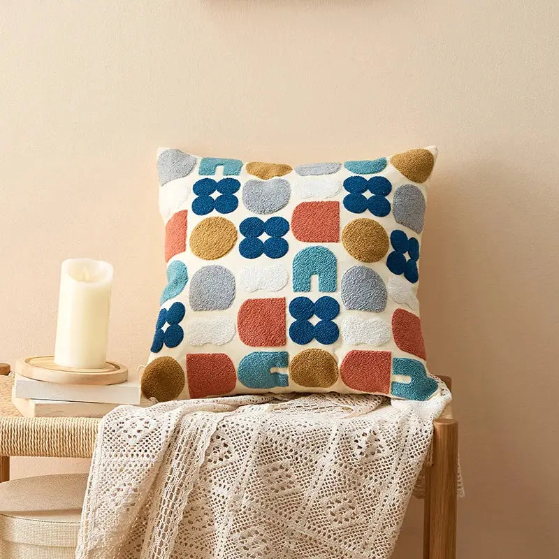 Embroidered floral dot pillow cover with textured geometric embroidery in blue orange and gray on cream for home decor