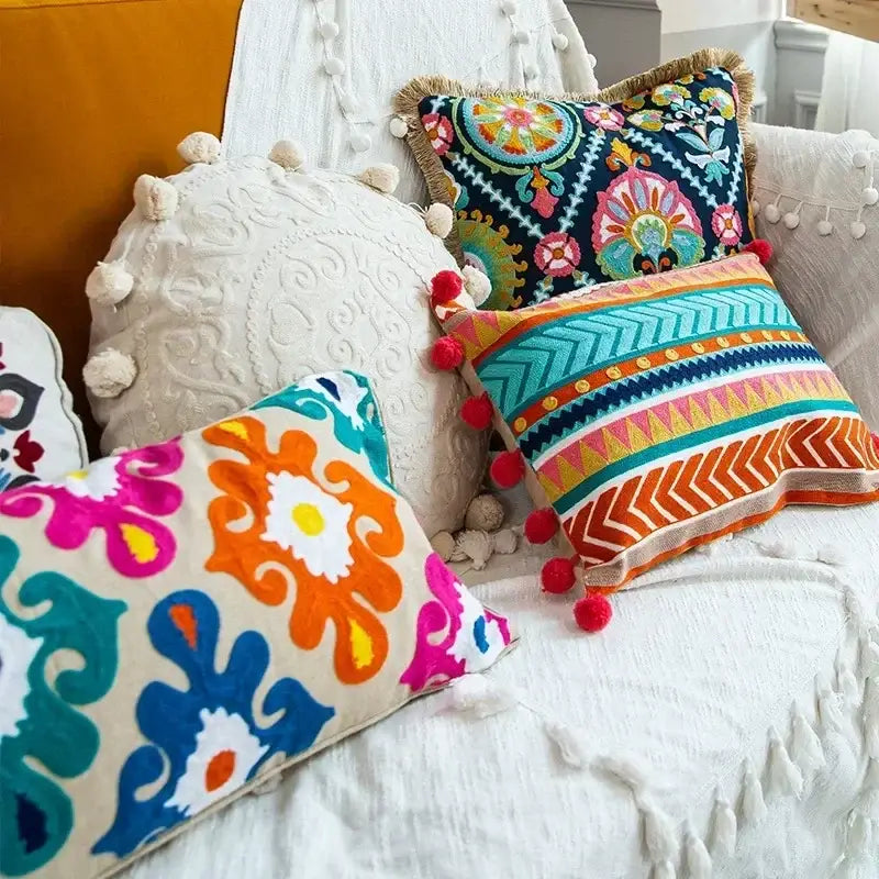 Vibrant embroidered flower boho long cushion covers with bold floral and geometric patterns on dark navy background