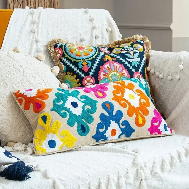 Vibrant embroidered flower boho long cushion cover with bold turquoise orange pink and yellow floral patterns on cream base