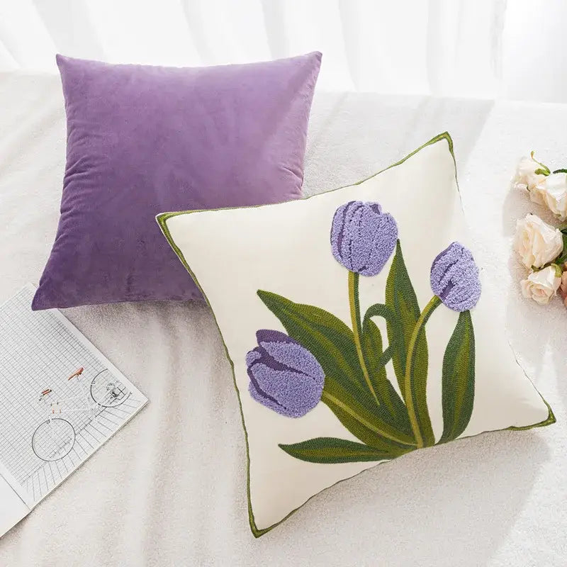 Cream-colored pillowcase cover with embroidered purple tulip and green leaf design accented by a green border