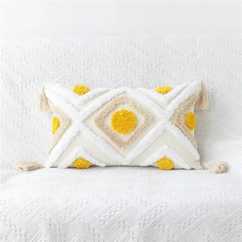 Rectangular cream pillow cover with embroidered geometric leaves pattern and bright yellow pom-poms for living room decor
