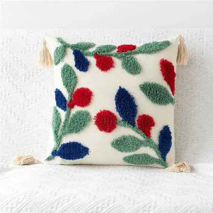 Cream-colored pillow cover with embroidered geometric leaves in red and blue and beige tassels for living room decor