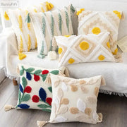 Cream-colored pillow cover with embroidered geometric leaves patterns and tassels for living room decor