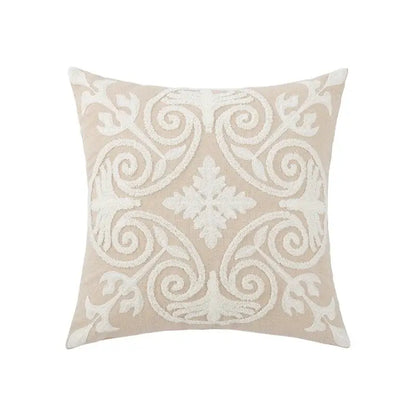 Beige square pillow cover with intricate white embroidered floral and scrollwork design for living room decor