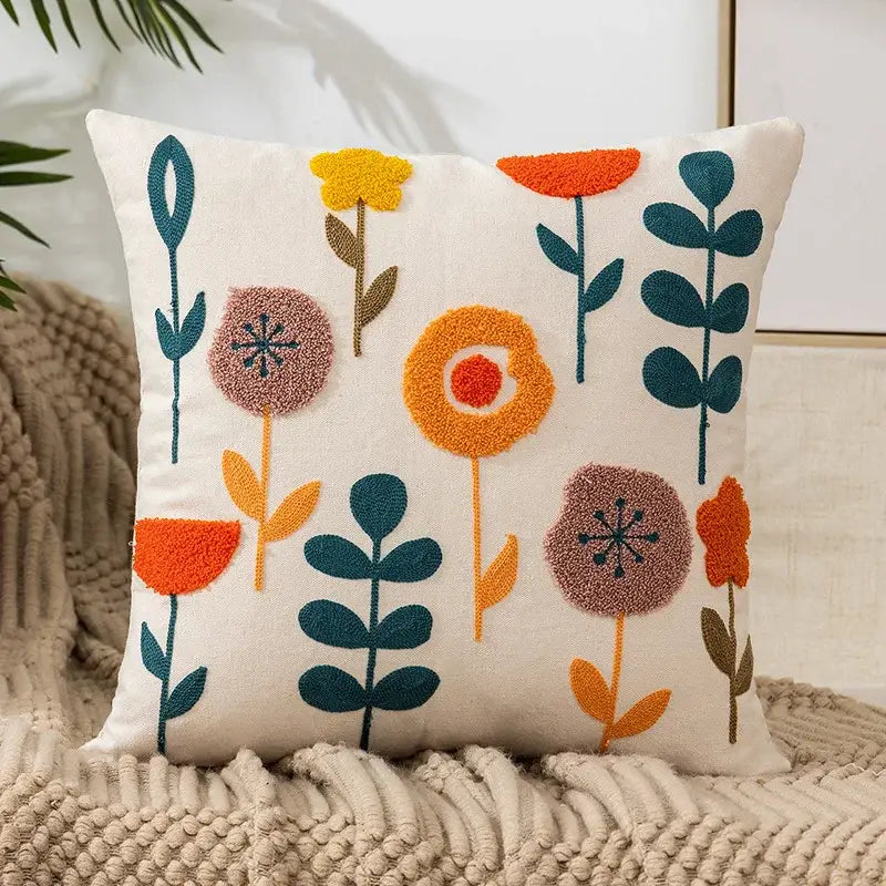 Cream-colored pillow cover with colorful orange teal mauve floral embroidery for living room decor