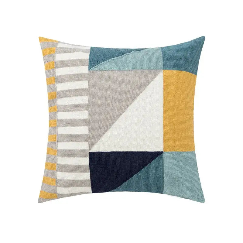 Geometric-patterned pillow cover with muted blues mustard yellow gray stripes and navy accents in textured fabric for living room