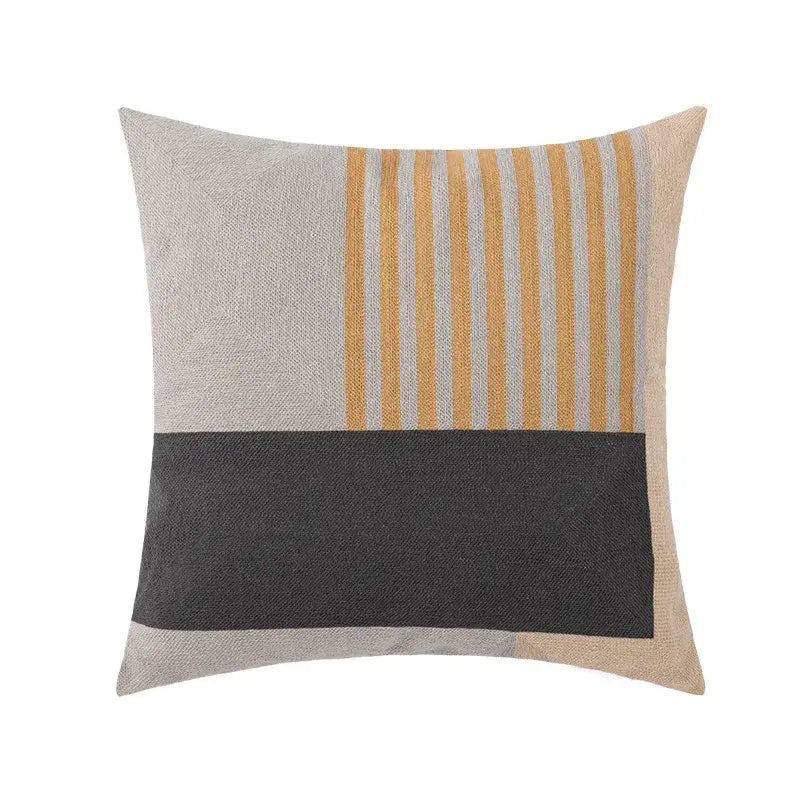 Square pillow cover with mustard yellow and light gray stripes and charcoal band on textured beige fabric background