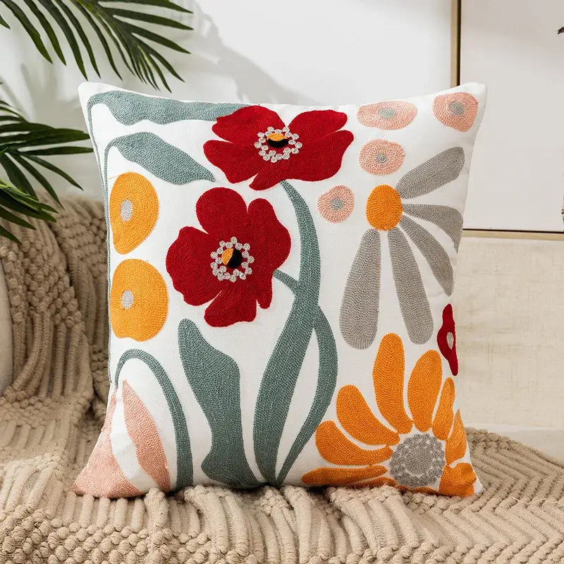 White cushion pillow cover with vibrant red orange gray embroidered flowers and sparkling centers for living room decor