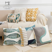 White pillow cover featuring embroidered green and gold fish pattern for living room with yellow floral accents