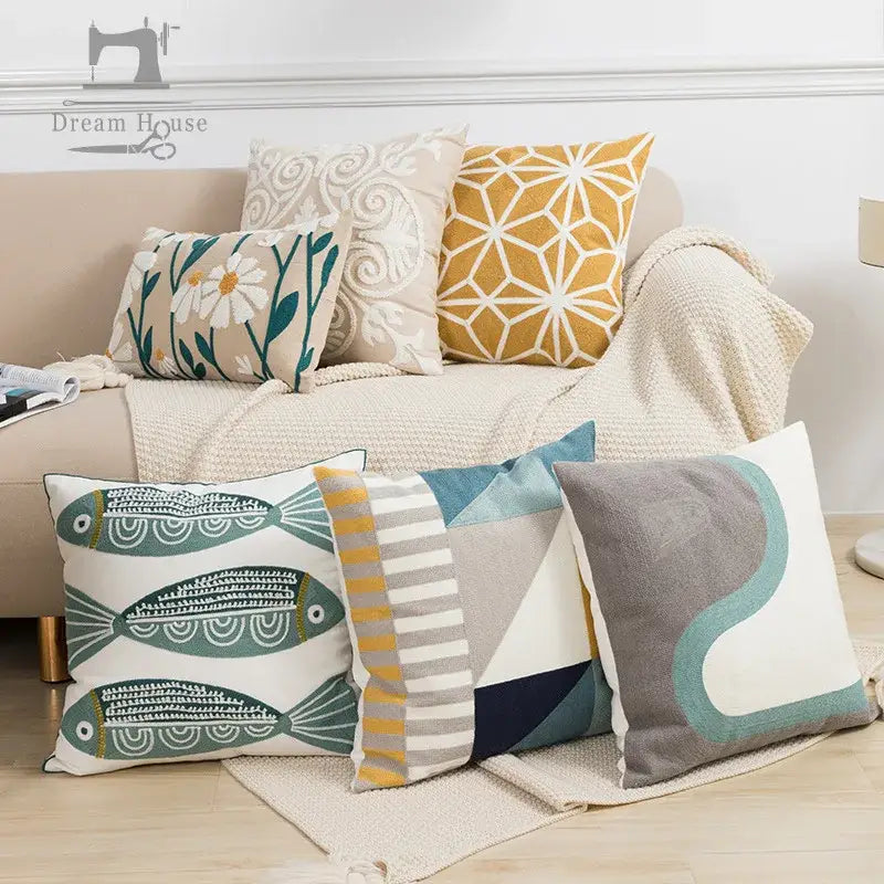 White pillow cover featuring embroidered green and gold fish pattern for living room with yellow floral accents