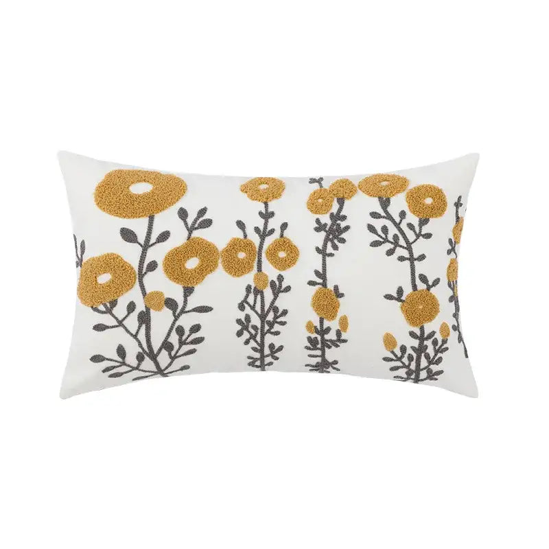 White rectangular pillow cover with embroidered daisy yellow floral and dark gray stems for living room decor