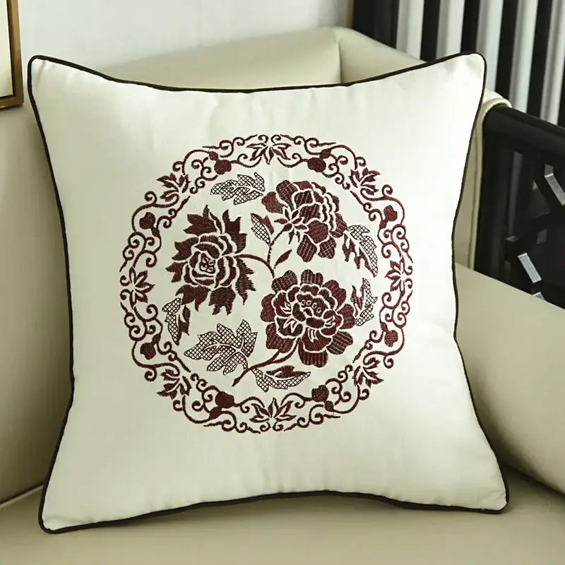 Cream-colored embroidered horse pillowcase with burgundy floral embroidery and dark brown piping for living room decor
