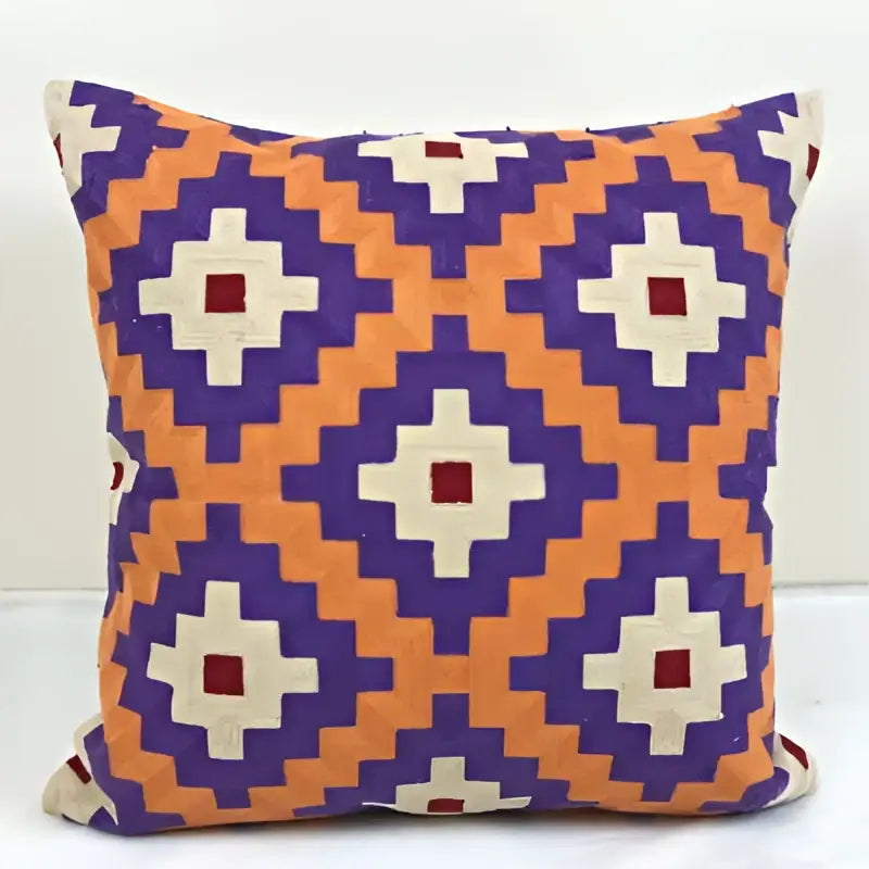 Vibrant embroidered kilim style cushion cover with bold orange purple and cream geometric diamond motif for living room use