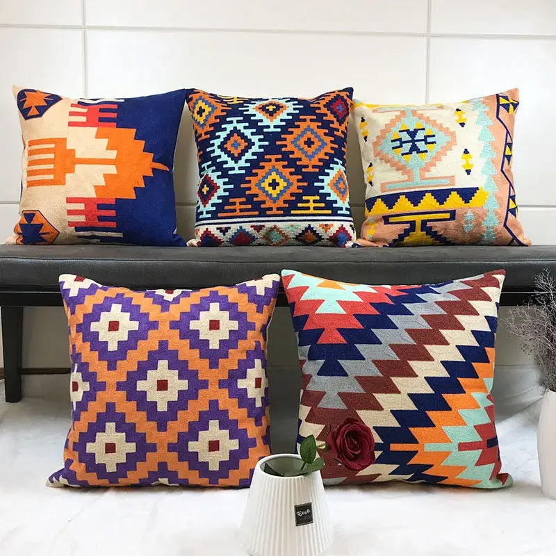 Vibrant embroidered kilim style cushion cover with geometric pattern in bold orange purple blue and red colors for living room