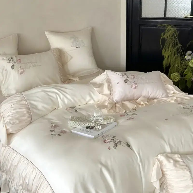 Cream-colored satin embroidery lace princess bedding set with delicate floral design and ruffled edges for bedroom decor