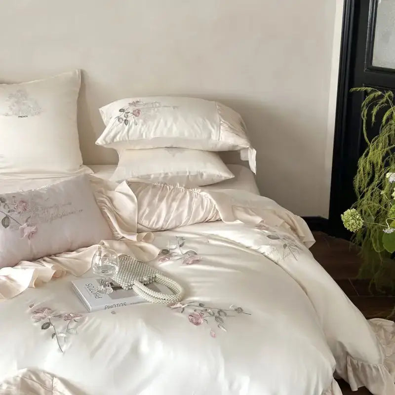 Cream-colored satin bedding set with delicate pink and green floral embroidery in embroidered lace princess style