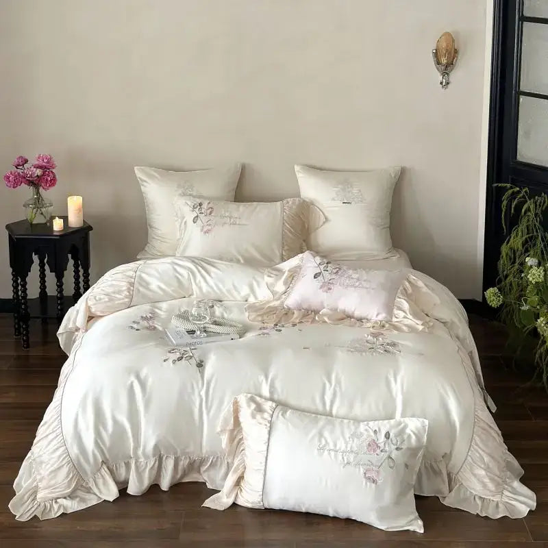 Cream-colored satin embroidered lace princess bedding set with delicate floral embroidery and ruffled edges for bedroom decor