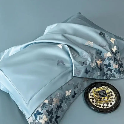 Light blue satin pillowcase with intricate decorbites butterflies embroidery in silver gray and white for bedding set