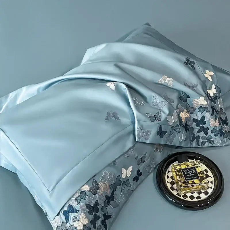 Light blue satin pillowcase with intricate decorbites butterflies embroidery in silver gray and white for bedding set