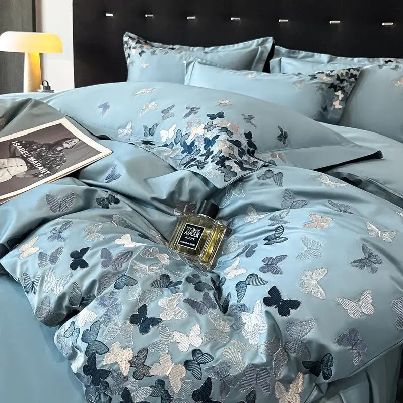 Light blue satin bedding set with intricate navy silver and white decorbites butterflies embroidery for bedroom decor