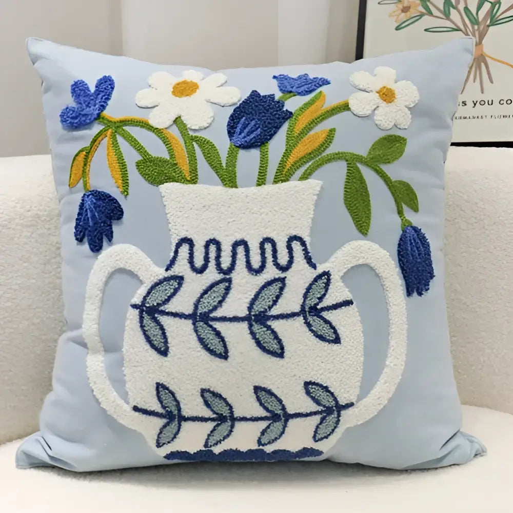 Light blue square pillowcase with blue hyacinth embroidery and white ceramic vase decorbites blue hyacinth design