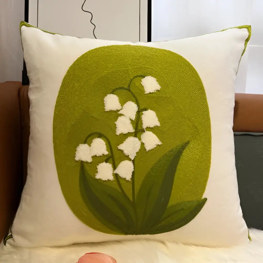 Cream-colored square pillowcase with embroidered lily of the valley on a green oval for decorbites blue hyacinth square