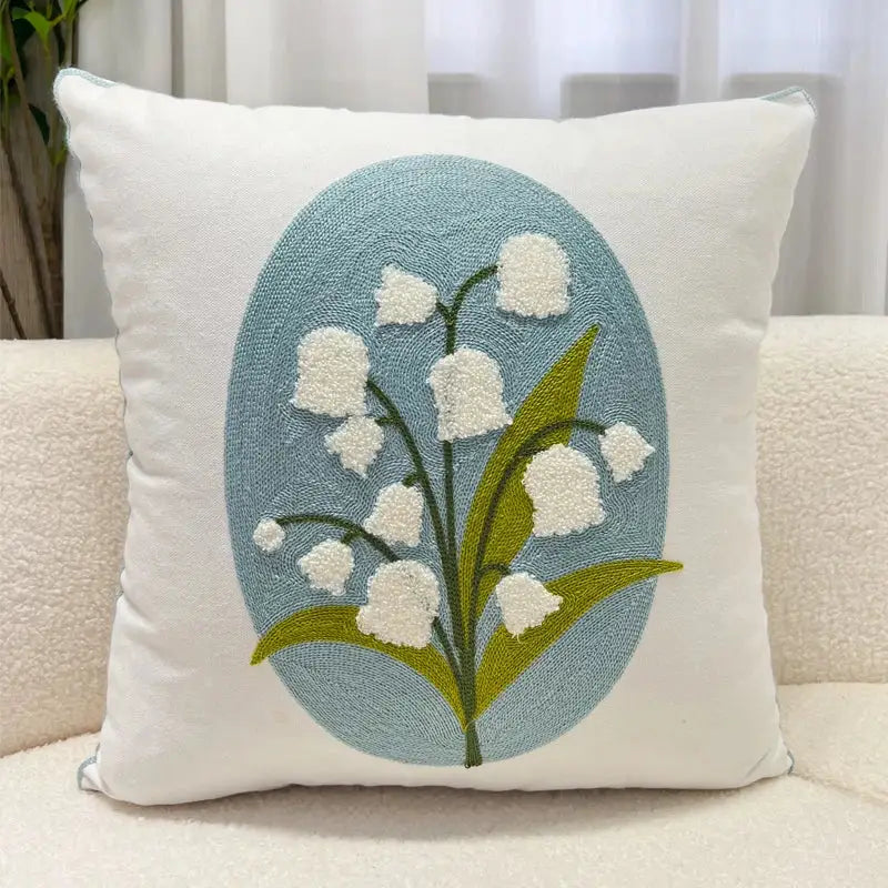 White square pillowcase with embroidered lily of the valley cluster on light blue oval background decorbites blue hyacinth