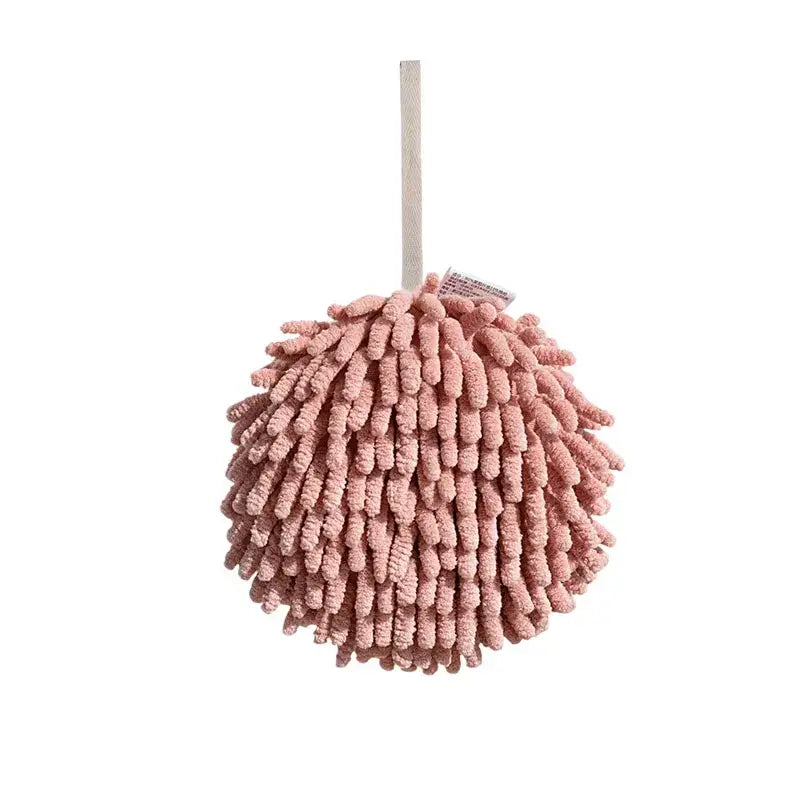 Pink fluffy microfiber cleaning mitt with wooden handle alongside pale green and cream embroidered microfiber hand towel