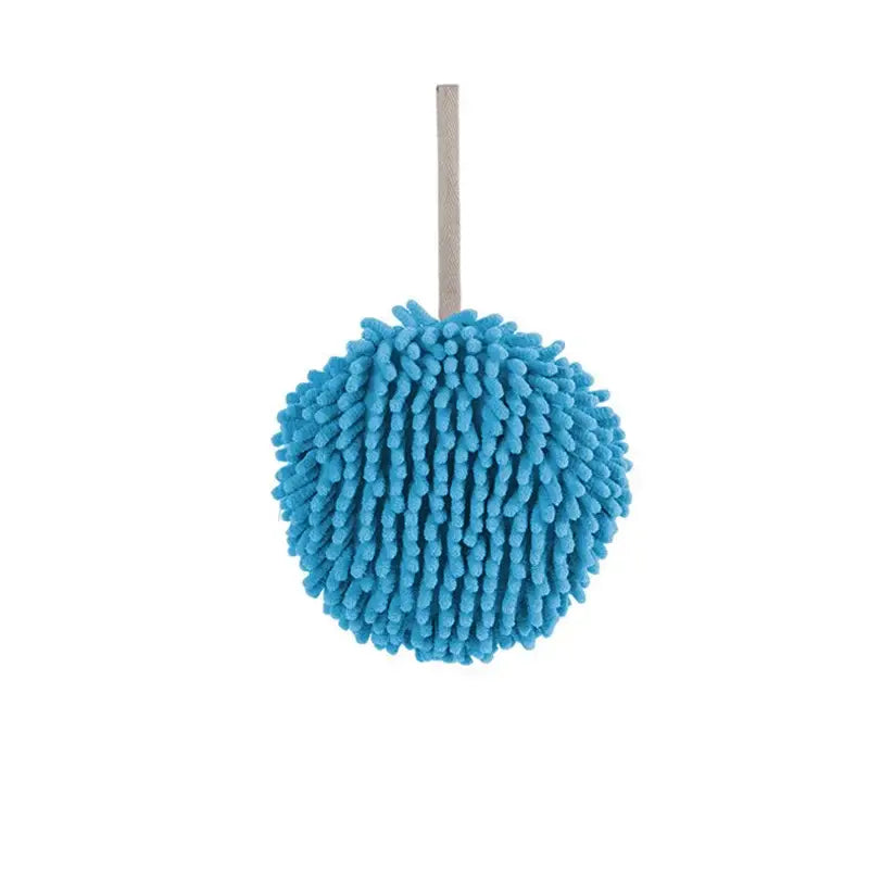 Bright blue microfiber car wash mitt with textured surface and metallic handle beside pale green and cream embroidered microfiber hand towel
