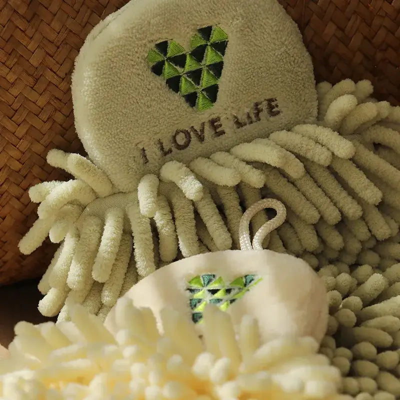 Cream-colored embroidered microfiber hand towel with green heart design and i love life text for kitchen decor