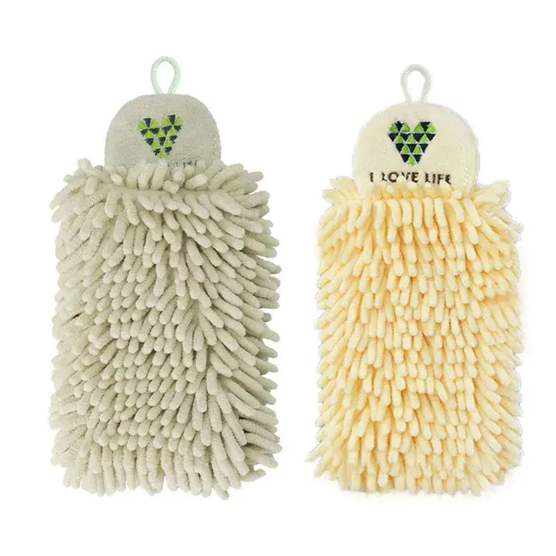 Two soft fluffy microfiber hand towels in pale green and cream with embroidered geometric hearts for kitchen decor