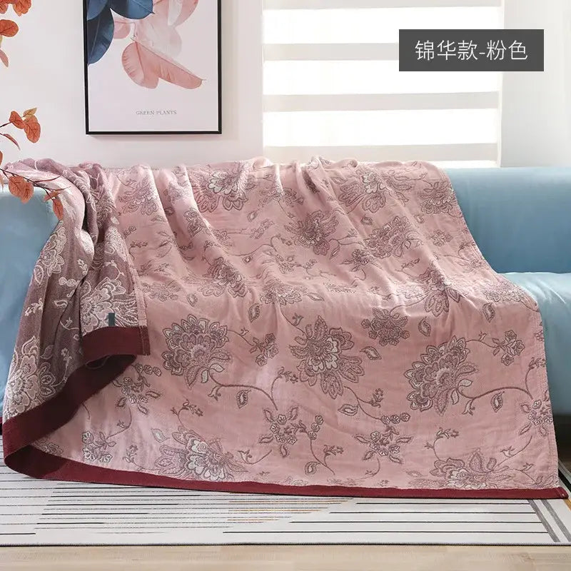 A soft pink quilted decorbites cotton gauze summer quilt with floral pattern and deep red border for bedroom decor
