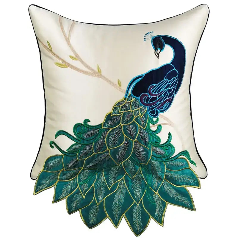 Cream satin cushion cover with an embroidered peacock design in teal navy and gold for living room decor