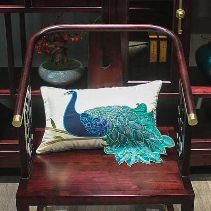 Rectangular cream satin cushion cover with an embroidered peacock design in teal and blue for living room decor