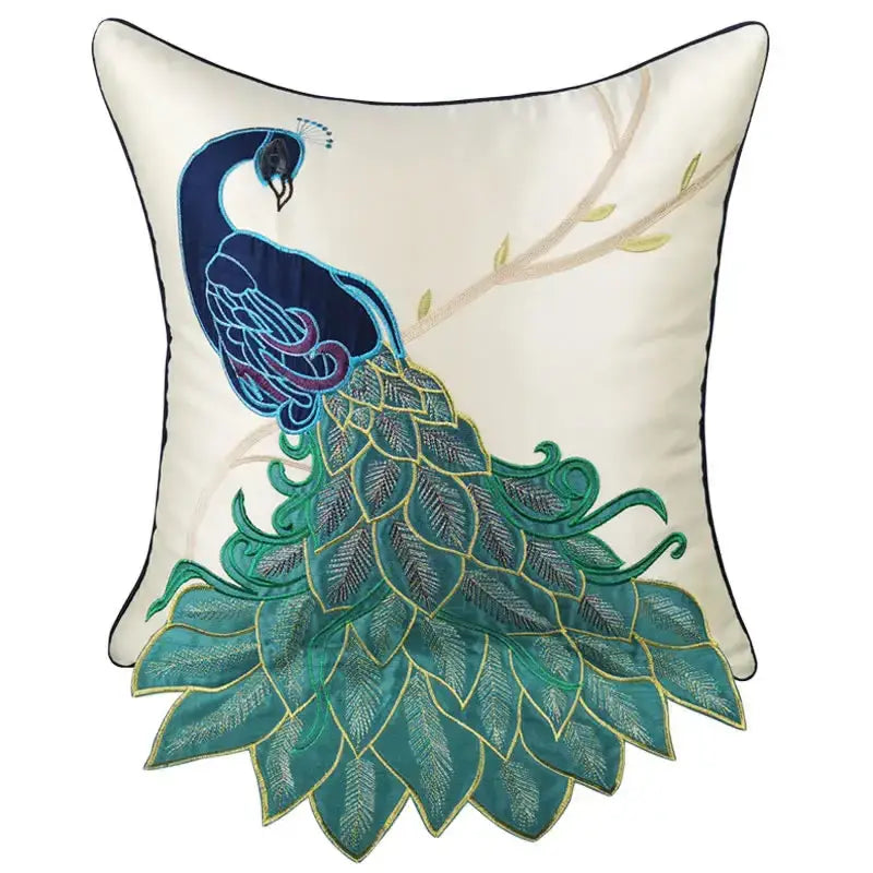 Cream satin cushion cover with an embroidered peacock design in deep blue teal purple and gold for living room decor