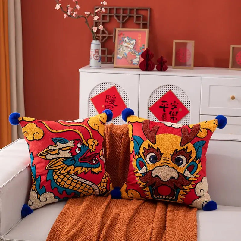 Vibrant red embroidered dragon year cushion cover with blue pom-pom accents for elegant living room decorbites dragon year decor