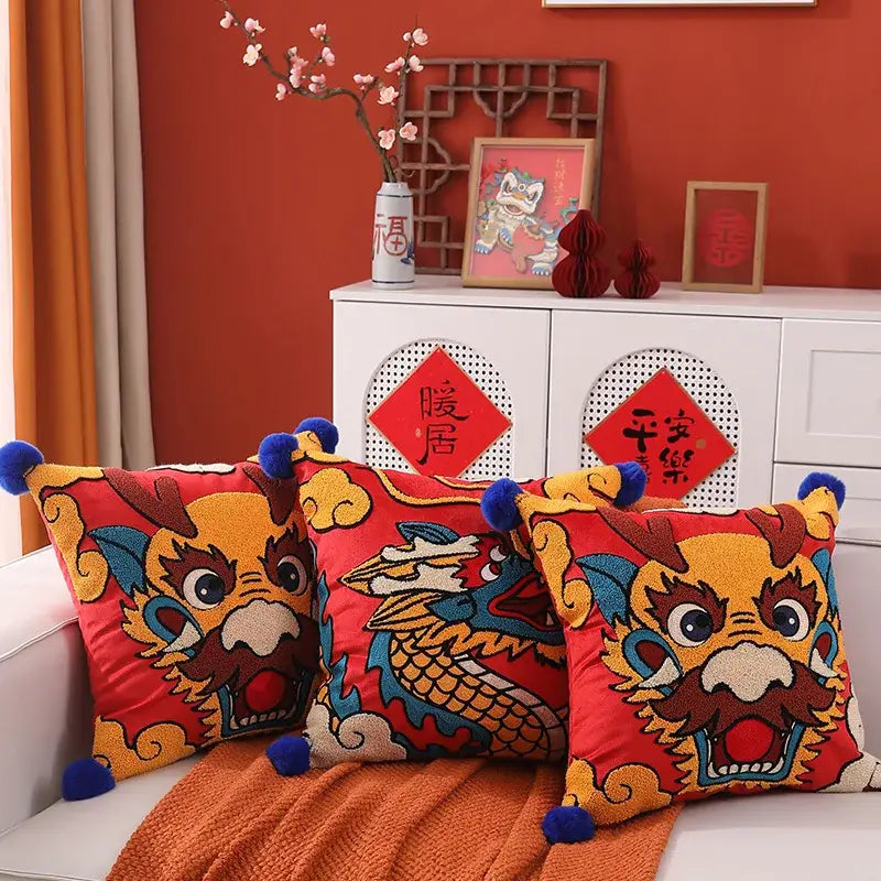 Red embroidered cushion cover with vibrant yellow and blue dragon year design and blue pom-poms for living room decorbites dragon year cushion