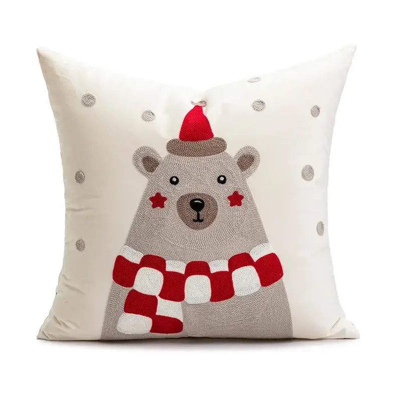 Cream-colored pillow cover with embroidered polar bear in santa hat and scarf, silver snowflakes, decorbites cartoon christmas decor