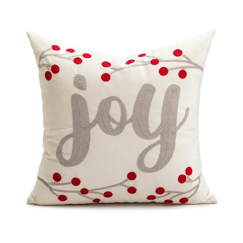 Cream-colored pillow cover with embroidered silver joy lettering and red berry accents for decorbites cartoon christmas decor