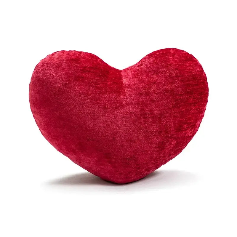 A plush red velvet heart cushion featured as part of decorbites cartoon christmas pillow covers for living room decor