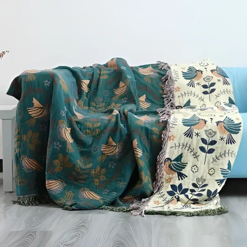 Embroidered teal and cream cotton sofa throw blanket with birds foliage pattern and fringed edges for living room use