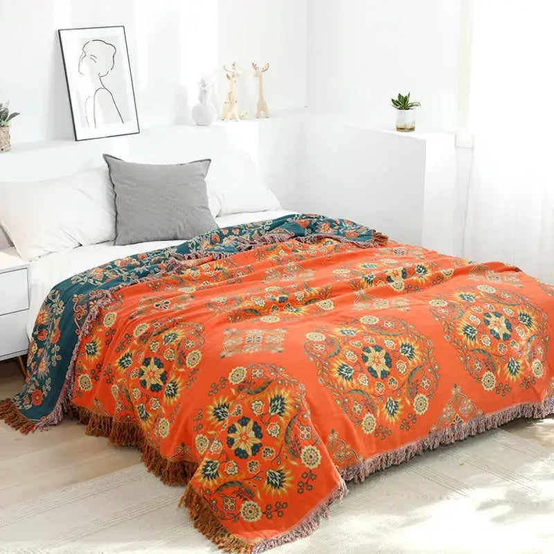 Vibrant orange embroidered cotton sofa throw blanket with teal cream floral patterns and fringed edge for living room