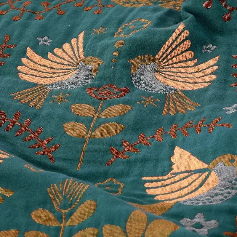 Embroidered teal and cream cotton sofa throw blanket with gold rust and gray bird and floral motifs for living room