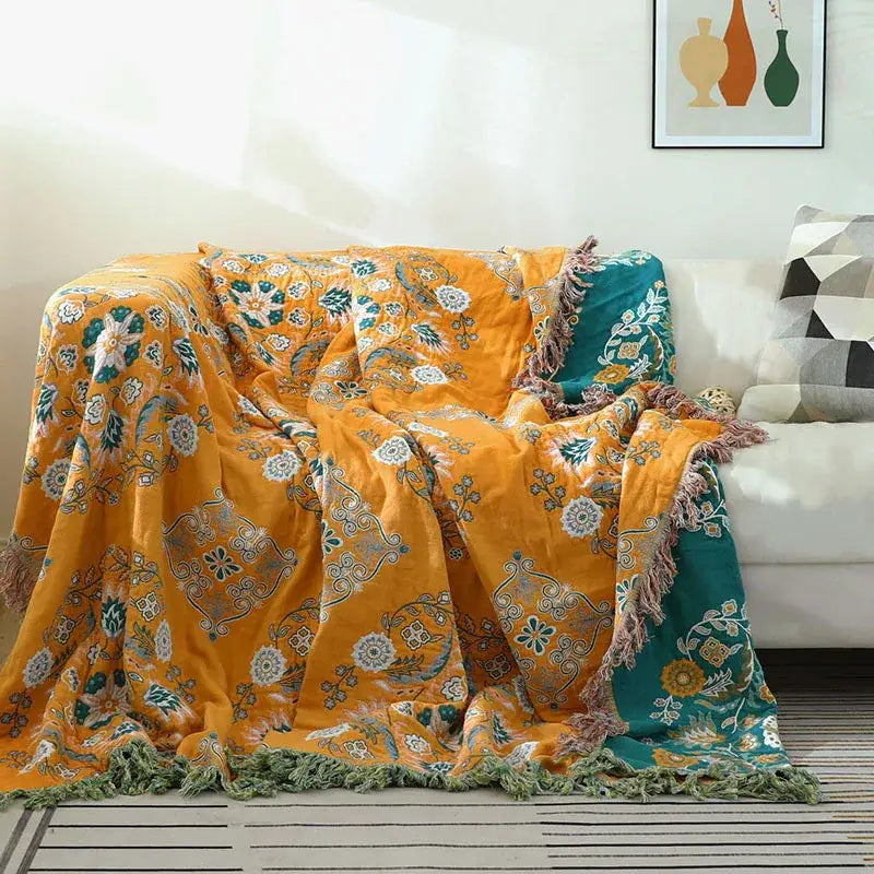 Vibrant orange and teal floral cotton sofa throw blanket with fringed edges for living room decor and comfort